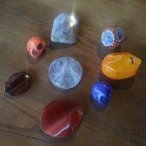 Some of the weights available for Shaman's Voice Pendulums as of December 6, 2013: purple and orange magnesite skulls, purple crazy lace agate, clear amethyst, faceted carnelian, red tiger's eye, botswana agate and orange coral.