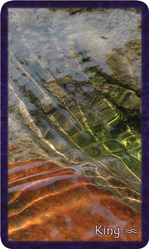 The King of Community card from the Gratitude Tarot features water flowing over earth with bright sunlight and places of green and rust. Photo and poetry by Teresa Deak.