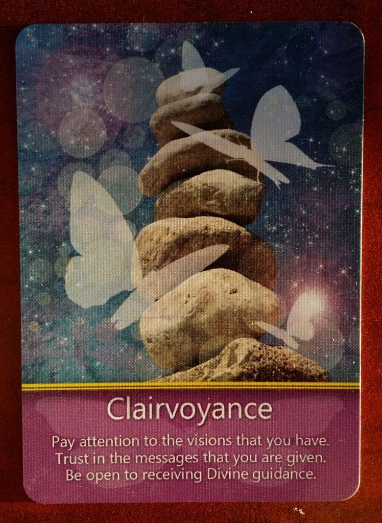 In the middle, from the Butterfly Visions Oracle deck, the Clairvoyance card. You have access to more knowledge than you think. Let the Divine guide you.